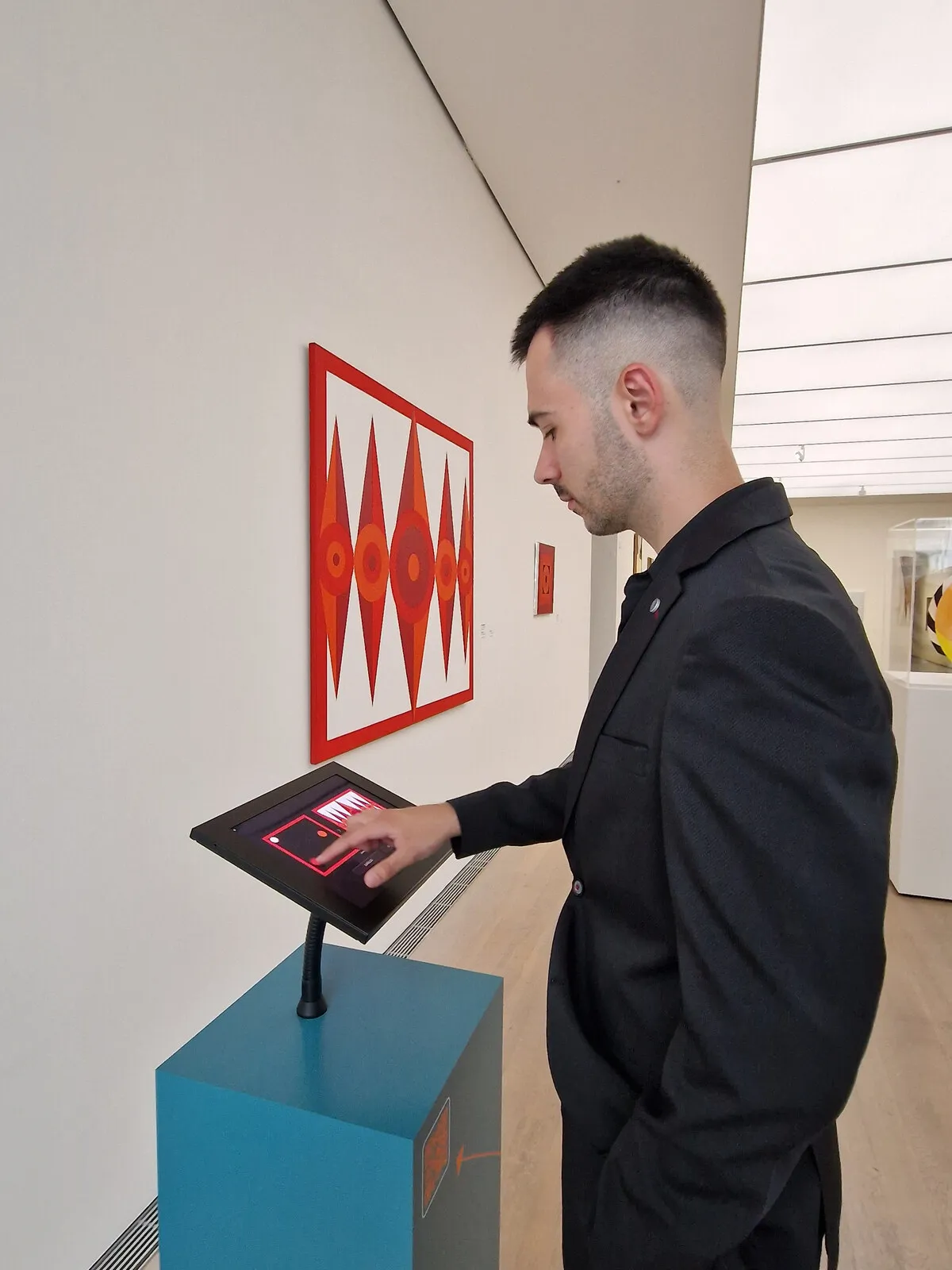 A kiosk running the Brenken episode in use, with the 1973 original hanging on the wall above it.
